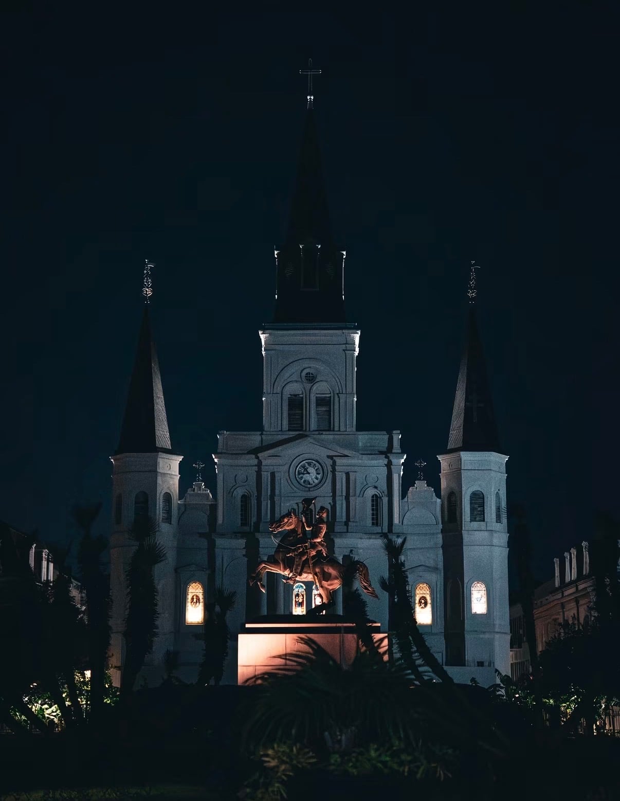 St. Louis Cathedral lit up at night above Jackson Square