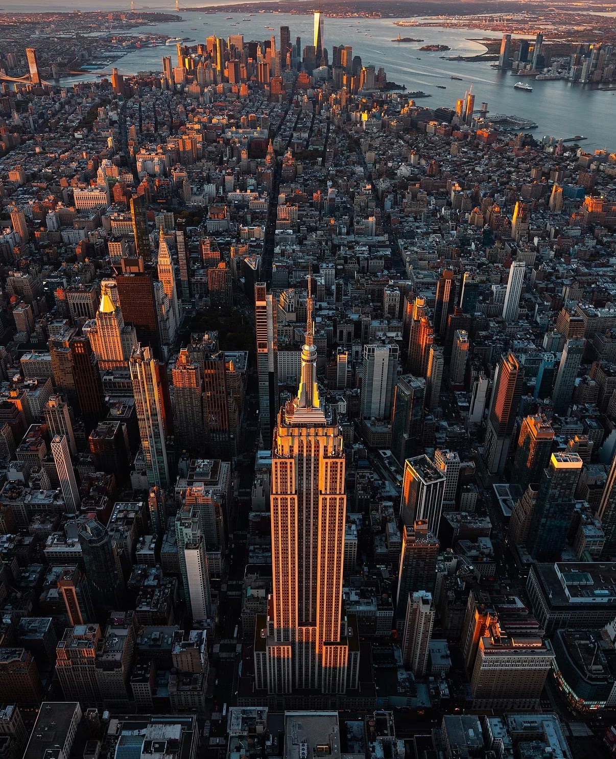 Aerial view of Midtown Manhattan with the Empire State Building catching late sun