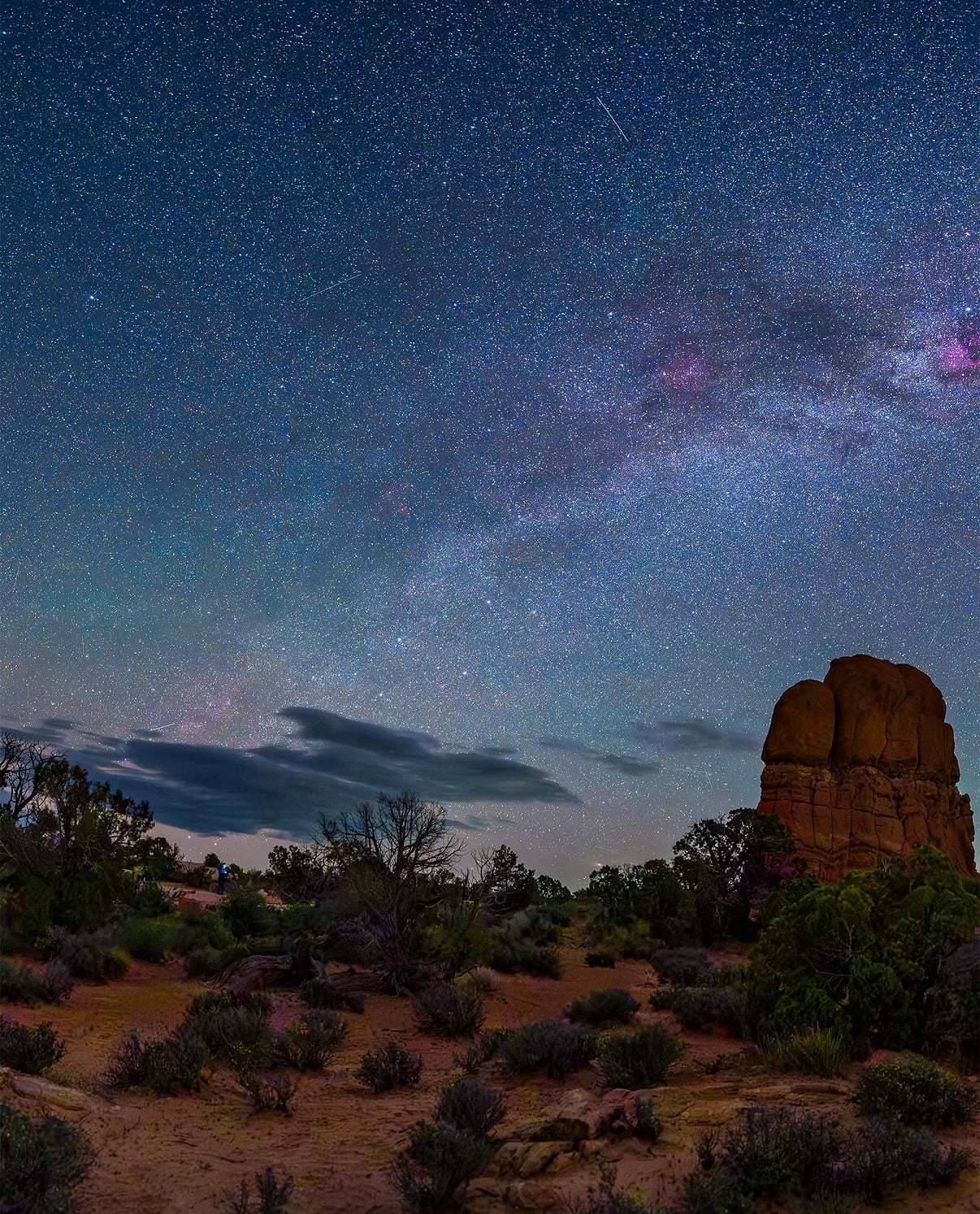 The Milky Way over a red-rock butte and desert scrub